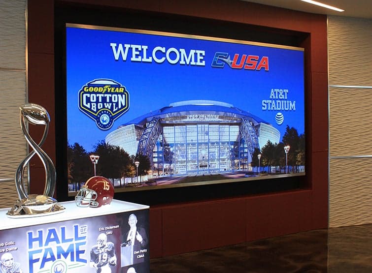 Welcome USA on a TV screen with awards in front